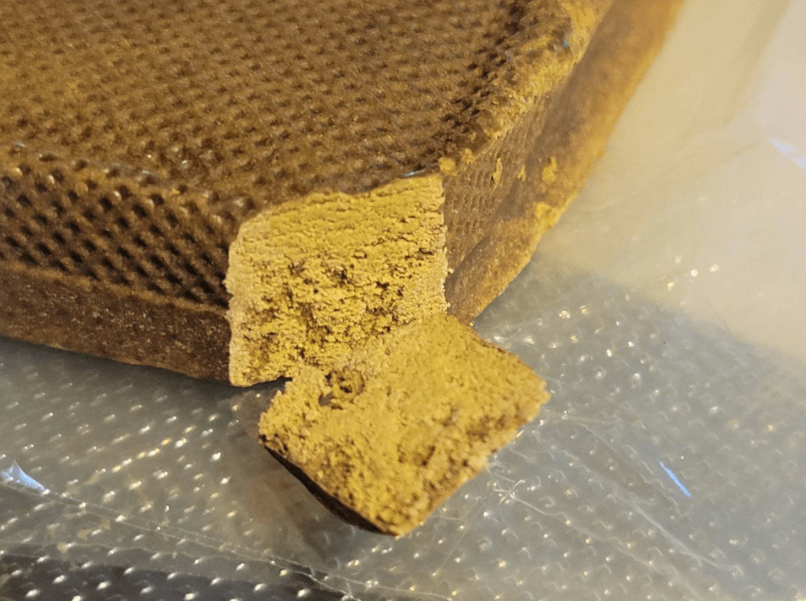 Cross-section of cannabinoid matrix hash showing uniform golden interior composition